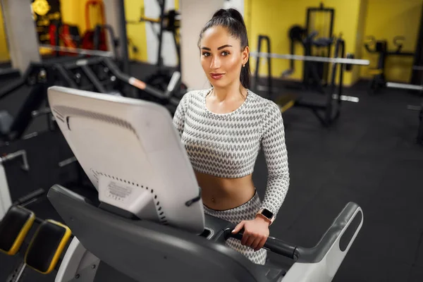 Junge gesunde Frau auf dem Laufband im Fitnessstudio — Stockfoto