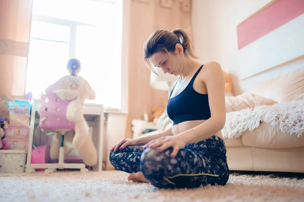 Woman is practicing yoga, gymnastic exercises for neck while sit