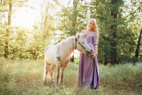 Mulher de vestido roxo abraçando cavalo unicórnio branco. Os sonhos vêm t — Fotografia de Stock