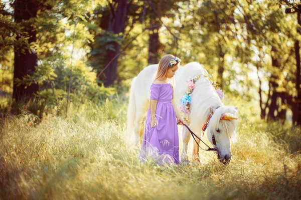 Menina em vestido roxo abraçando cavalo unicórnio branco. Os sonhos vêm tr — Fotografia de Stock