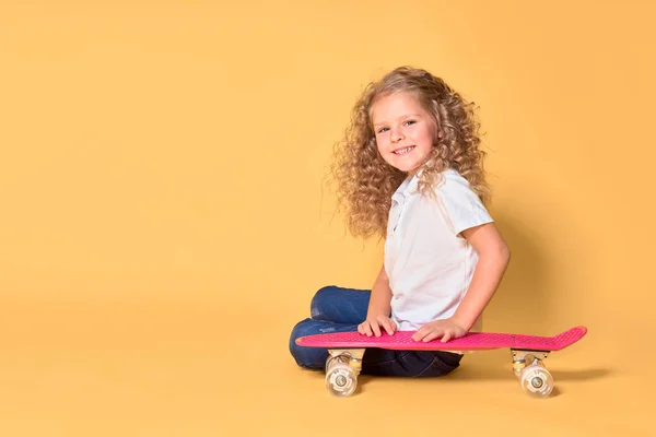 Active and happy girl with curly hair, headphones having fun wit