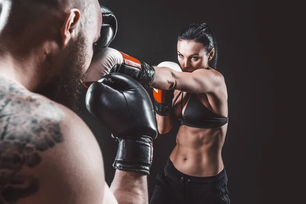 Mujer sin camisa haciendo ejercicio con entrenador en el boxeo y defensa personal — Foto de Stock