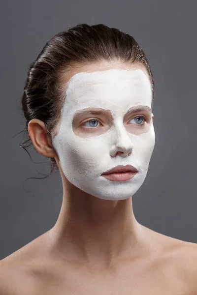 Beautiful girl is applied a white cosmetic mask from black dots. Isolate, studio — Stock Photo, Image