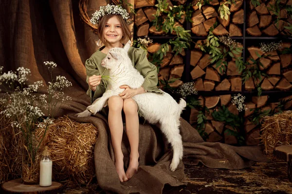 可爱的农场姑娘抱着她的小白山羊喂它 — 图库照片