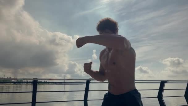 Tätowierter Mann Straßenboxer beim Workout-Training Kampf mit Schatten. Hochwertiges 4k-Filmmaterial, Zeitlupe. Handheld — Stockvideo