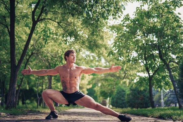 Jeune fitness homme coureur étirant les jambes avant de courir — Photo