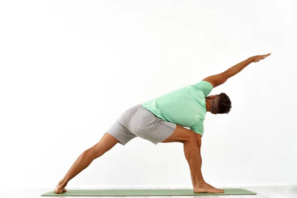 Achteraanzicht van sportieve man die yoga beoefent in yogales, terugstrekkend. Gezonde levensstijl, Yoga Oefening Class Concept — Stockfoto