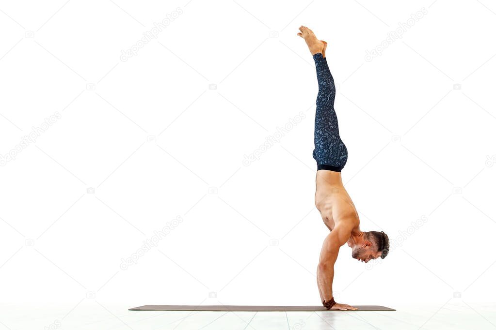 Young man acrobatics gymnastic doing a handstand studio isolated on white background, athletic sportsman