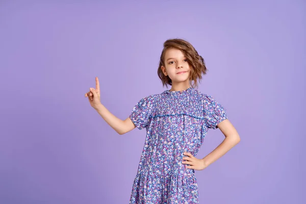 Look There. Excited Caucasian Kid Girl Pointing Thumb At Free Space For Text Posing On Purple Studio Background. Panorama — Stock Photo, Image