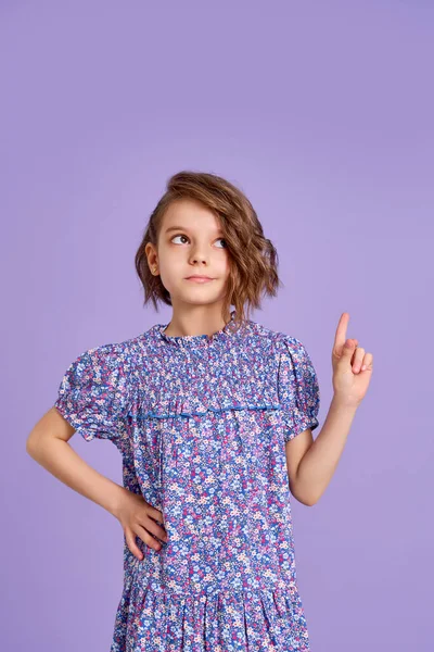 Look There. Excited Caucasian Kid Girl Pointing Thumb At Free Space For Text Posing On Purple Studio Background. Panorama — Stock Photo, Image