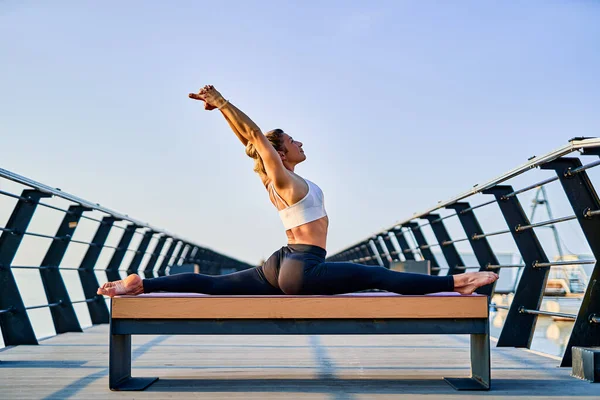 Mujer bastante joven haciendo ejercicio de yoga sobre la naturaleza en la mañana. —  Fotos de Stock