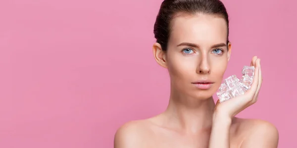 Mooie vrouw met natuurlijk uitziende make-up houden ijsblokjes in de buurt gezicht — Stockfoto