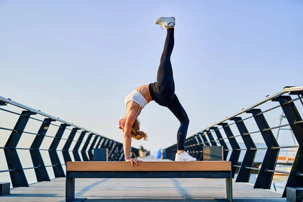 Mulher bonita fazendo exercício de ioga sobre a natureza pela manhã. — Fotografia de Stock