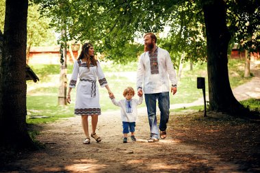 Happy family with little son in traditional ukrainian dress clipart