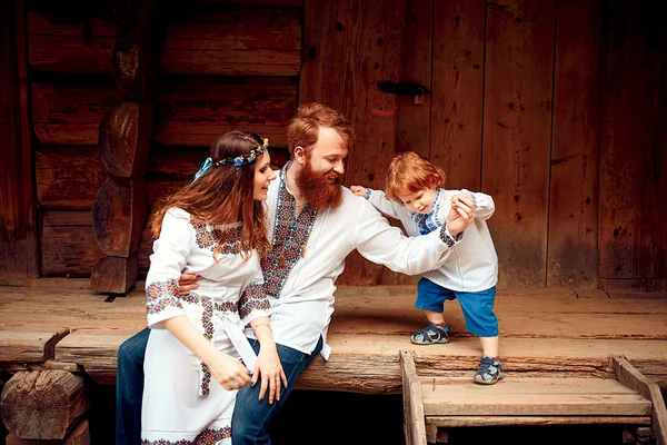 Família feliz com filho pequeno em vestido tradicional ucraniano — Fotografia de Stock