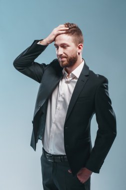 Şık takım elbise, renkli tiffany arka plan, bir şık sakallı adam stüdyo çekim düşünme, üzgün, çok duygusal izole