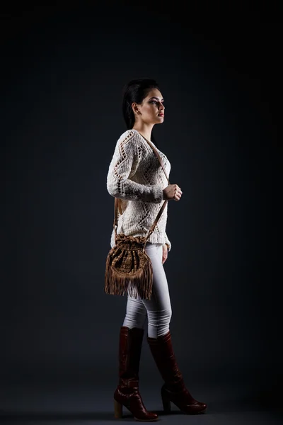 Красивая брюнетка в бежевом свитере и коричневой сумке — стоковое фото
