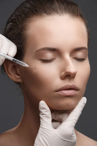 Portrait of young Caucasian woman getting cosmetic injection — Stock Photo, Image
