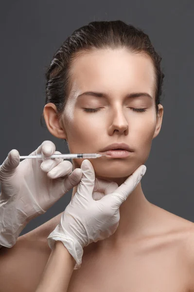 Portrait of young Caucasian woman getting cosmetic injection — Stock Photo, Image