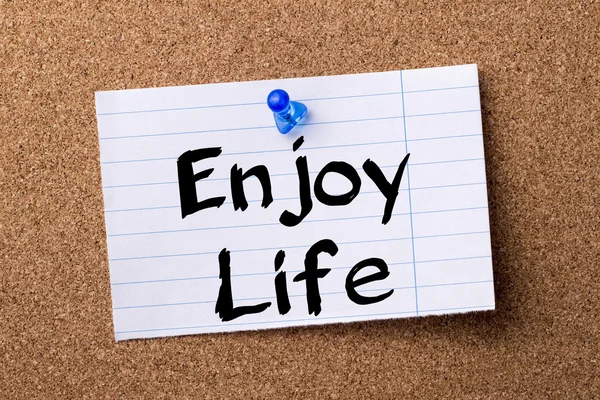 Enjoy Life - teared note paper pinned on bulletin board — Stock Photo, Image