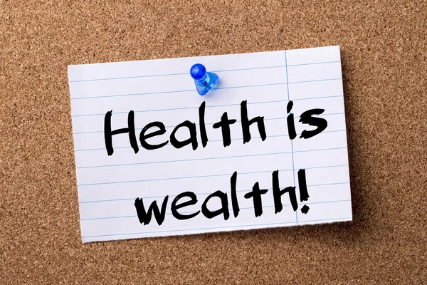 Health is wealth!  - teared note paper pinned on bulletin board — Stock Photo, Image