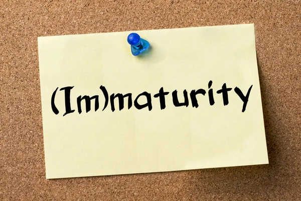 (Im)maturity - adhesive label pinned on bulletin board