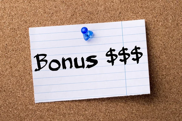 Bonus $$$ - teared note paper pinned on bulletin board — Stock Photo, Image