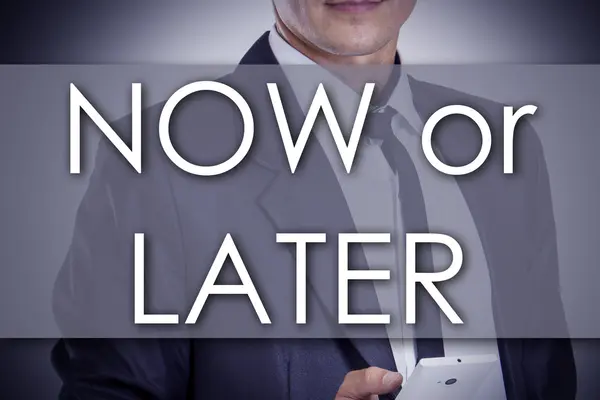 NOW or LATER - Young businessman with text - business concept — Stock Photo, Image