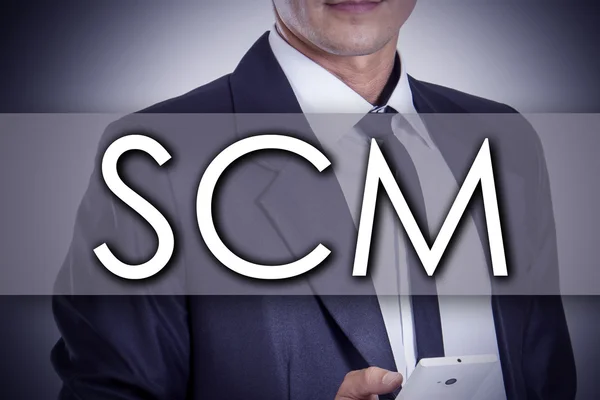 Supply Chain Management SCM - Young businessman with text - busi — Stock Photo, Image