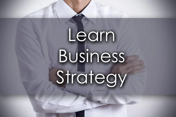 Nauczyć się strategii biznesowej - młody biznesmen z tekstem - firmy — Zdjęcie stockowe