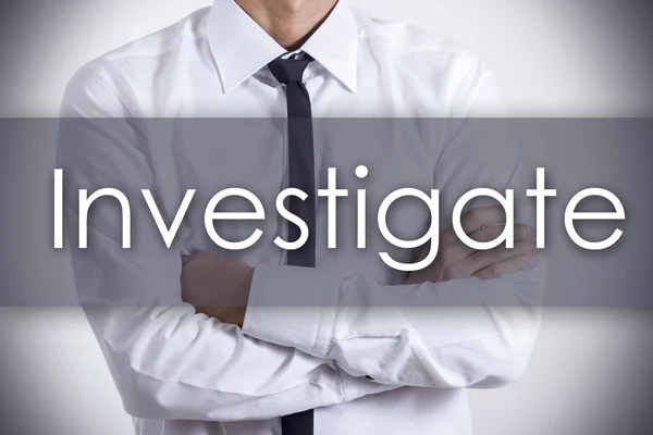 Investigate - Young businessman with text - business concept — Stock Photo, Image