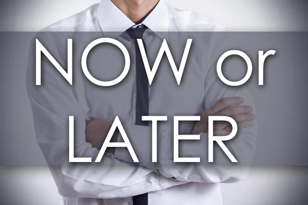 NOW or LATER - Young businessman with text - business concept — Stock Photo, Image