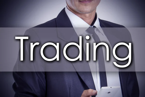 Trading - Young businessman with text - business concept — Stock Photo, Image