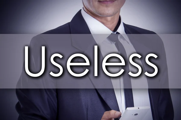 Useless - mladý podnikatel s textem - obchodní koncept — Stock fotografie