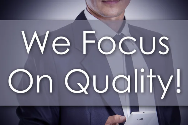 We Focus On Quality! - Young businessman with text - business co — Stock Photo, Image
