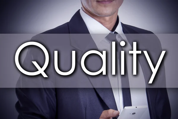 Quality - Young businessman with text - business concept — Stock Photo, Image