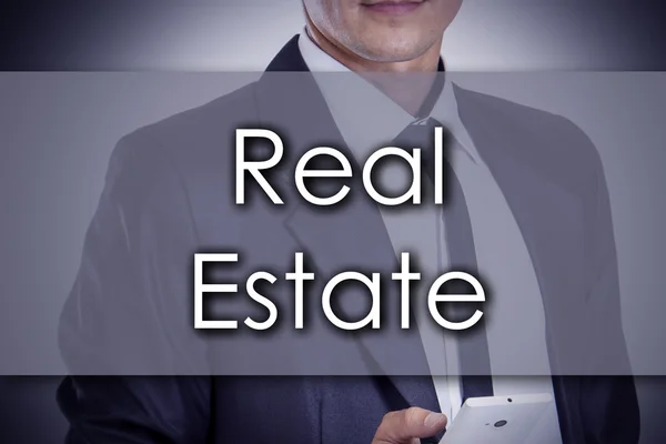 Real Estate - νεαρός επιχειρηματίας με κείμενο - επιχειρηματική ιδέα — Φωτογραφία Αρχείου