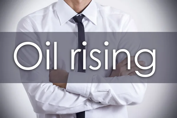 Oil rising - Young businessman with text - business concept