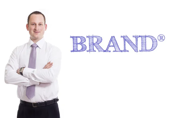 Brand (R) - Young businessman with blue text — Stock Photo, Image