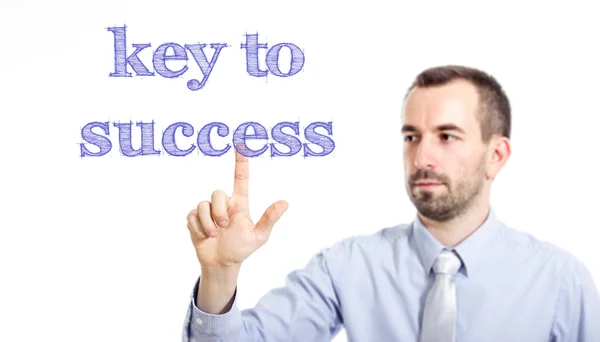 Ключ к успеху - Молодой бизнесмен с синим текстом — стоковое фото