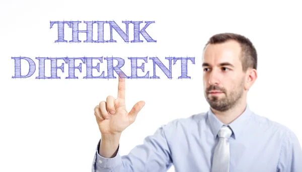 Pensar diferente - Joven hombre de negocios con texto azul —  Fotos de Stock