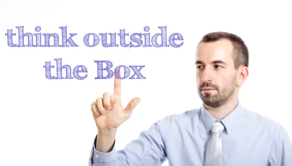 Tänka utanför boxen - ung affärsman med blå text — Stockfoto