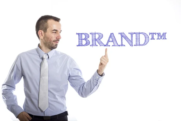 BRAND tm - Young businessman with blue text — Stock Photo, Image