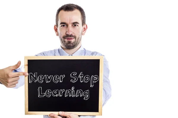 NEVER Stop Learning - Young businessman with blackboard - isolated on white — Stock Photo, Image