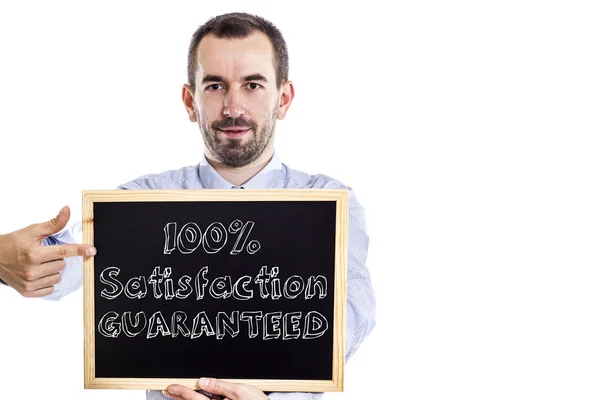 100% Satisfaction GUARANTEED - Young businessman with blackboard — Stock Photo, Image