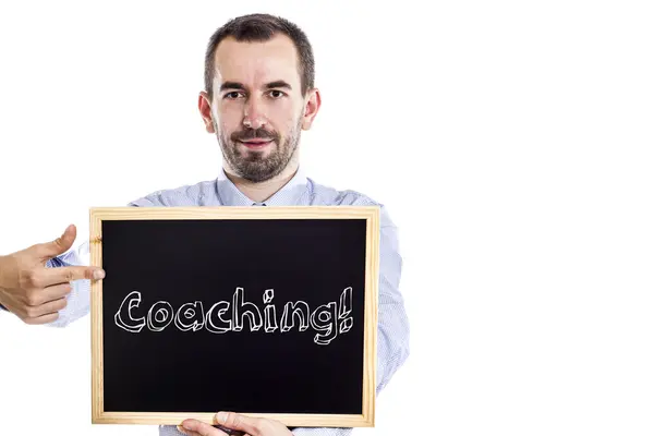 Coaching! - Young businessman with blackboard — Stock Photo, Image