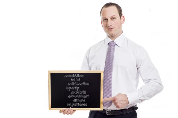 Conviction Trust Satisfaction Loyalty Goodwill Commitment Delight - Young businessman with blackboard — Stock Photo, Image