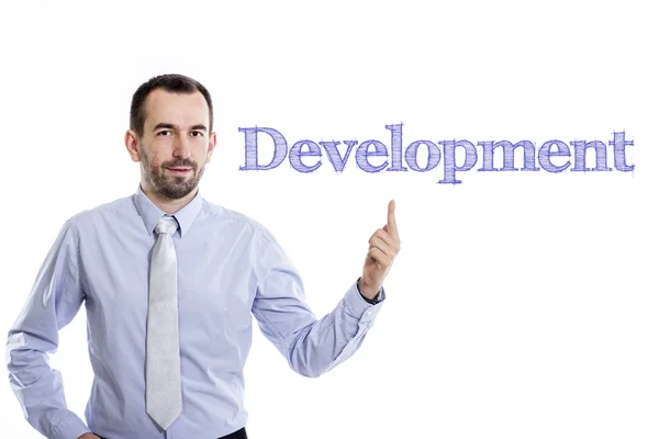 Развитие - Молодой бизнесмен с синим текстом — стоковое фото