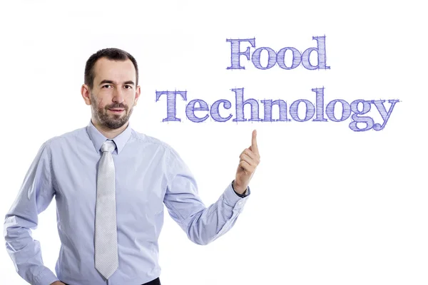 Food technology - Young businessman with small beard pointing up in blue shirt — Stock Photo, Image