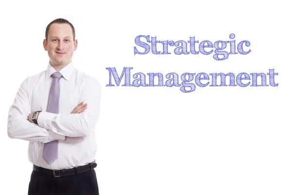 Стратегическое управление - Молодой бизнесмен с синим текстом — стоковое фото